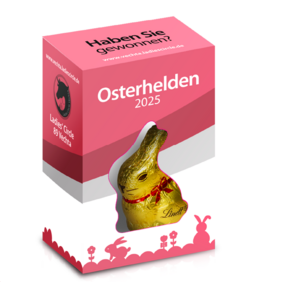 Die Verpackung der Schokohasen der Osterhelden Aktion. Der obere Teil ist pink. Der untere weiß. Am unteren Rand sind pinke Silhouetten von Osterhasen und Ostereiern zu sehen. In der Mitte der Verpackung ist ein Sichtfenster in dem der Lindt-Schokoladenhase zu sehen ist. 